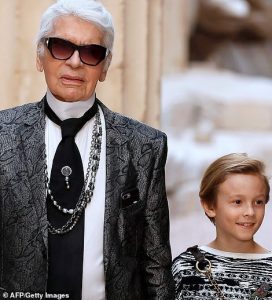 Karl Lagerfeld posing with his beautiful Birman cat in a photo from Choupettes official Instagram left and with his godson Hudson right another potential heir to his fortune