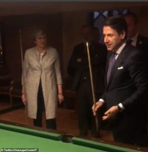 Theresa May is handed a cue by Italian PM Giuseppe Conte and then says to him you have to 1 1