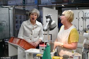 British Prime Minister Theresa May speaks with Valerie Muni during a visit to the Portmeirion factory in Stoke on Trent on January 14