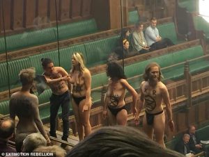 Semi naked climate change protesters interrupted a Commons debate on Brexit tonight as they stripped off in the public galler